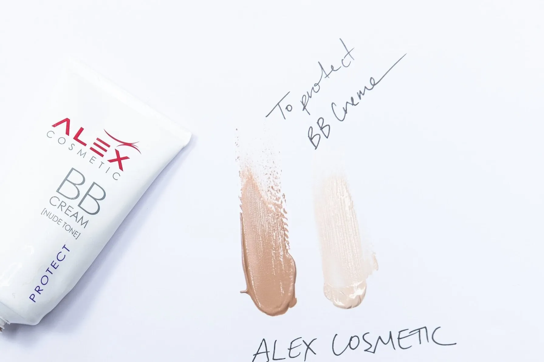An Alex Cosmetics BB cream tube beside two swatches of the cream